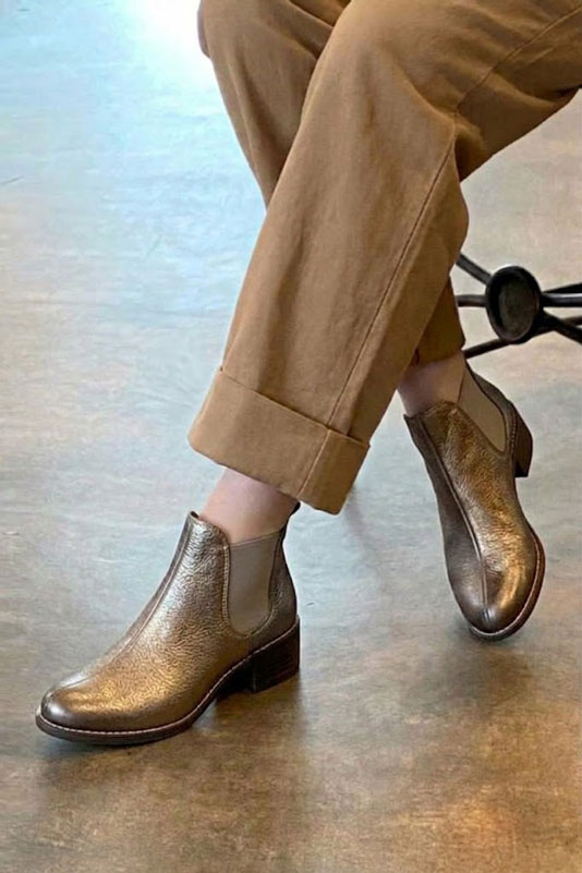 Women's antique gold and bronze solid-color chelsea boots with round toe and leather sole - Worn view